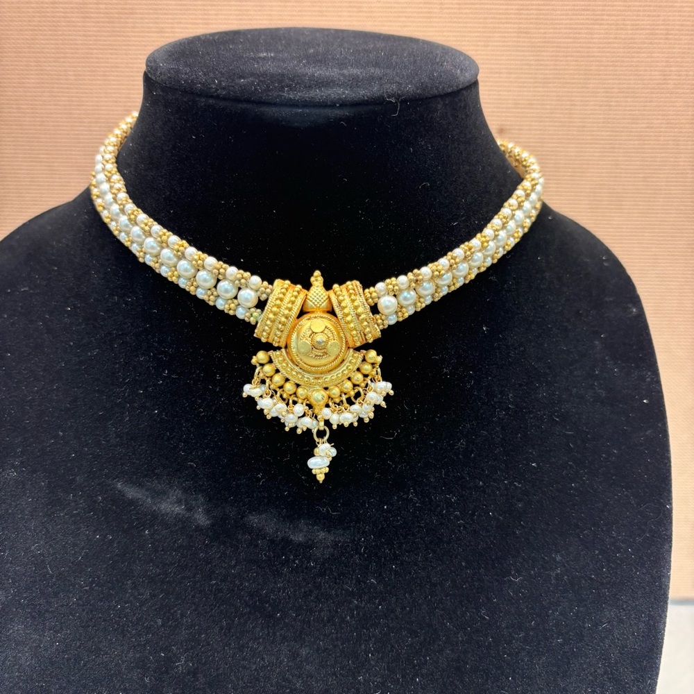 Gold and White Ornate Necklace with Intricate Metalwork